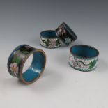 Two pairs of cloisonne napkin rings, decorated with flowers,