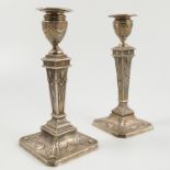 Two silver candlesticks, with Classical moulded decoration, London 1902,