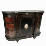 A 19th ebonised credenza, having central paneled door with portrait plaque ,