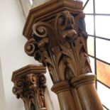 A pair of wooden columns, with Corinthian capitals, to a cluster column and fielded panelled base,