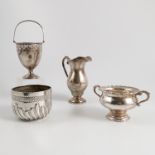 Four hallmarked silver items, a swing handle pedestal vase with pierced edge,