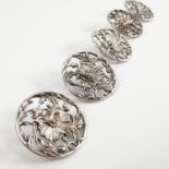 A set of five silver buttons, with pierced floral decoration,