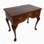 An 18th century style walnut lowboy, having quarter veneer and cross banded top,