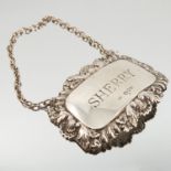 A silver bottle ticket, engraved Sherry, with embossed border,