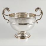 A silver pedestal bowl, with a pair of scroll handles,