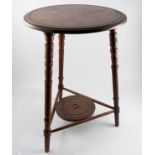 A 19th century cricket table, raised on three turned legs, united by circular shelf,