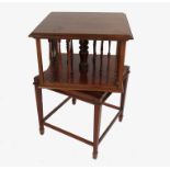 A small square shaped revolving bookstand, raised on four tapering legs,