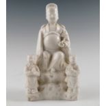 A blanc de chine Chinese figure, of Imperial with attendance,