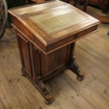 A 19th century walnut davenport, the rising lid, opening to reveal birdseye maple fitted interior,