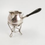 A silver brandy warming pan, with turned wooden handle, on a silver stand with scrolling supports,