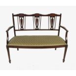 An Edwardian mahogany triple chair back settee, with boxwood marquetry inlay,