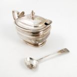 A Georgian silver covered mustard pot, with gadrooned edge, the lid engraved with a crest,