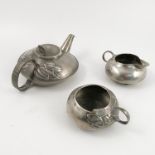 A Liberty pewter three piece tea set, designed by Archibald Knox,