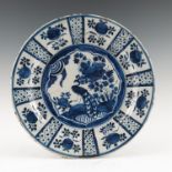 A Kraak saucer dish, decorated in blue and whites with central peacock,