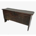 An Antique oak coffer, with rising lid, over carved front, raised on stile feet,