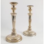 A pair of Georgian silver candlesticks, with gadrooned and fluted decoration,