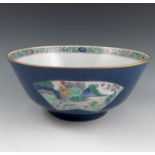 A Kang Xi STYLE bowl, the blue exterior decorated with reserved panels and flowers,