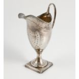 A Georgian silver cream jug, with bright cut decoration, raised on a square foot, London 1788,