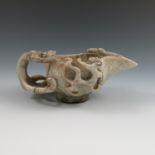 A Ming/Qing jade pouring vessel, with a dragon handle and two dragons to the sides,