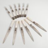 A set of six silver and mother of pearl handled fruit knives, with engraved blades, Sheffield 1904,