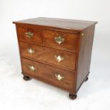 A 19th century chest of drawers, fitted two short drawers over two long drawers, raised on bun feet,