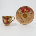 A Royal Worcester cabinet cup and saucer, decorated with fruit to a mossy background,