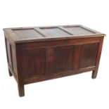 An Antique oak coffer, the fielded rising top having three fielded panels to the front, width 47ins,