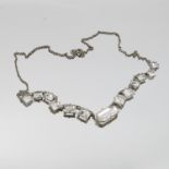 A colourless paste metal set necklace