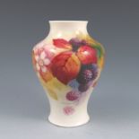 A Royal Worcester baluster shaped vase, hand painted with autumn berries and leaves, signed K Blake,