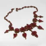 A Bohemian garnet necklace, the frontispiece of graduated star clusters with drops beneath,