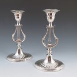 A pair of silver plated Mappin and Webb candlesticks, the column formed as a lyre,