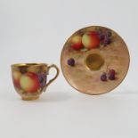 A Royal Worcester cabinet cup and saucer, decorated with fruit to a mossy background by H Aryton,