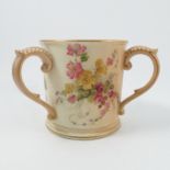 A Royal Worcester blush ivory three handled loving mug, decorated with floral sprays, dated 1903,