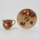 A Royal Worcester cabinet cup and saucer, decorated with fruit to a mossy background by E Townsend,