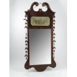 A Georgian design fret cut mirror, with panel of floral decoration over the mirror plate,