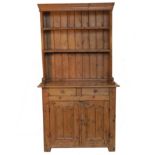 A 19th century pine dresser, with close boarded plate rack over,