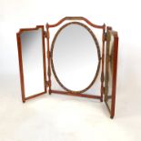 A satinwood tryptic folding mirror, with carved decoration to the central mirror and frame,