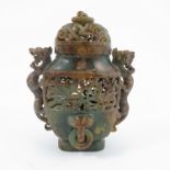 An Oriental carved soap stone covered vase, with pierced decoration, figural handles and ring masks,