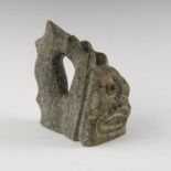 A carved hardstone figure, of a stylized mask, possibly Oriental or Pacific Islands, height 3.