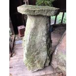 A tall stone staddle stone base,