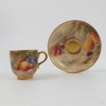 A Royal Worcester cabinet cup and saucer, decorated with fruit to a mossy background by Ricketts,