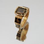 An early Victorian black enamel and gold mourning ring,