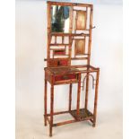 A Japanese style bamboo hall stand, fitted with a mirror, shelf and drawer, width 27ins,