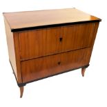 A Biedermeier style chest, of two drawers, raised on slightly out swept feet,