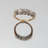 A five stone diamond ring, unmarked, the graduated old brilliant cuts totalling approximately 1.