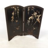 A small Oriental two fold screen, decorated with foliage and birds,