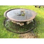 A large circular iron cauldron,