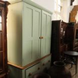 A painted pine kitchen free standing unit, the top section with two doors opening to reveal shelves,