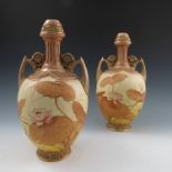 A pair of Royal Worcester blush ivory vases, with pierced tops, embossed necks, a pair of handles,