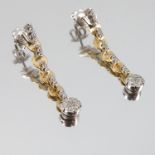A pair of diamond drop earrings, stamped '750', the articulated drops with cluster terminal, 6.